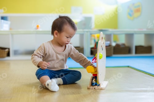 Preview: Toddler playing with wooden toy