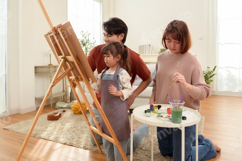 Preview: Family Time Spent Together Painting in a Bright Room With a Child and Parents Enjoying Their Activit