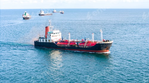 Preview: Fleet of oil tanker ships navigating the blue ocean in daylight. Global maritime logistics, energy t