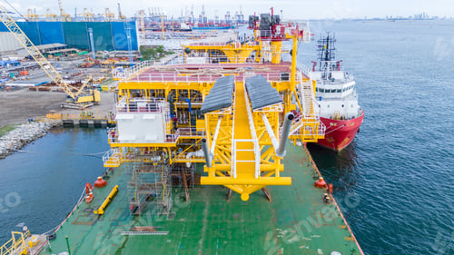 Preview: Offshore Oil and Gas Platform Structure Loaded on a Heavy Transport Barge With a Supply Vessel at a