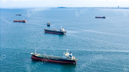 Preview: Fleet of oil tanker ships navigating the blue ocean in daylight. Global maritime logistics, energy t
