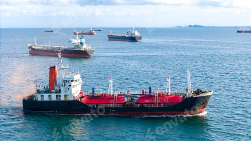 Preview: Fleet of oil tanker ships navigating the blue ocean in daylight. Global maritime logistics, energy t