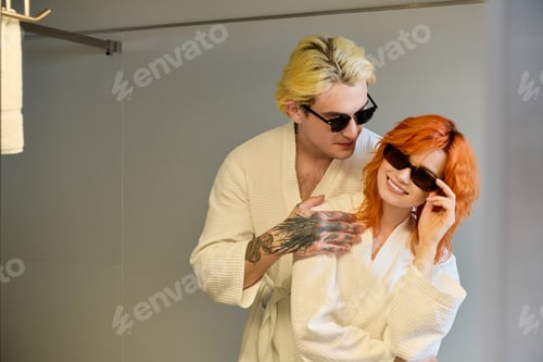 Preview: Young couple enjoying summer bliss at a stylish hotel in vacation attire