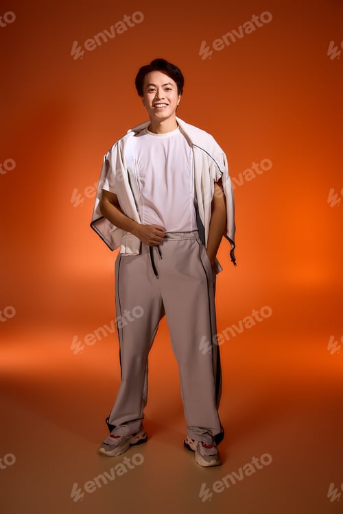 Preview: Stylish young man embraces modern fashion trends in vibrant studio setting