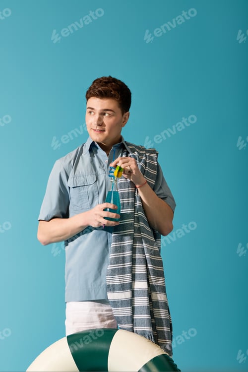Preview: Stylish young man enjoying summer vibes with a refreshing drink by the poolside