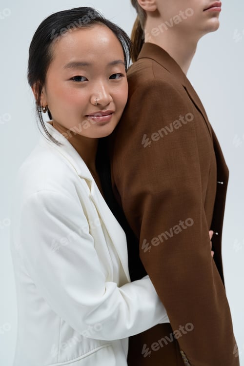 Preview: Loving couple sharing a moment of connection in a minimalist studio setting