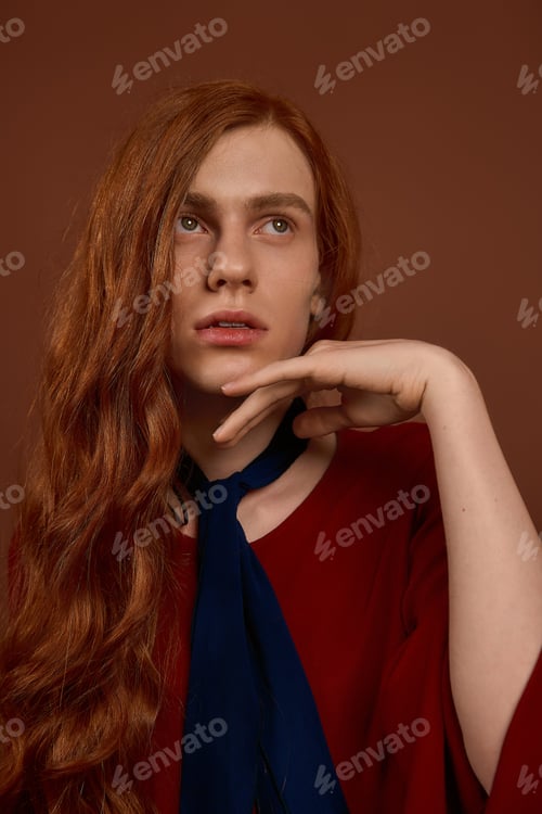 Preview: Handsome young man with flowing red hair showcasing elegance in stylish attire