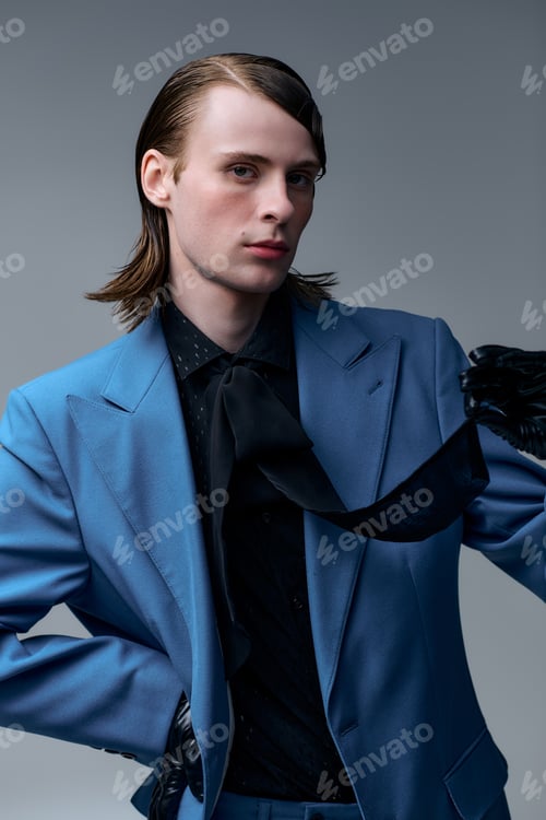 Preview: Portrait of a young man showcasing stylish elegance in a modern studio setting