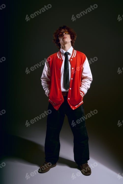 Preview: Emotional young man with curly hair showcases unique style and confidence in modern setting