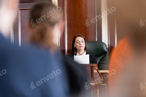 Preview: Prosecutor Reading Lawsuit in Court Near People on Blurred Foreground