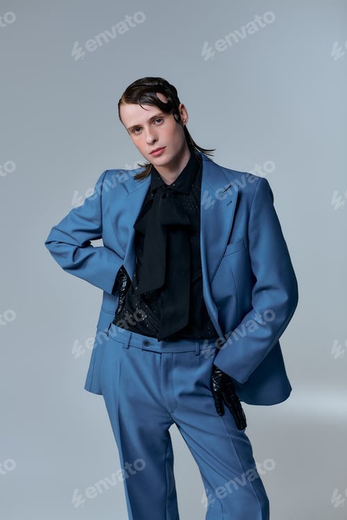 Preview: Young man showcases modern fashion in stylish suit during studio session