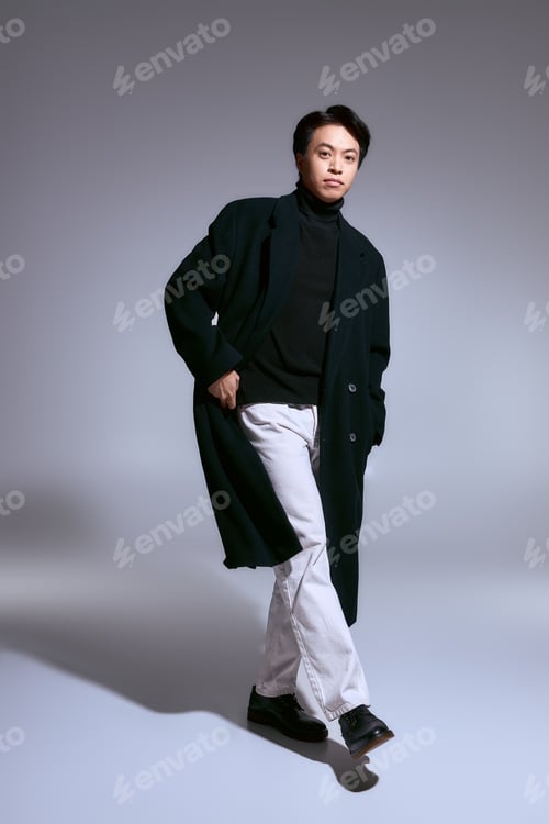 Preview: Confident young man in stylish fashion within a modern studio backdrop