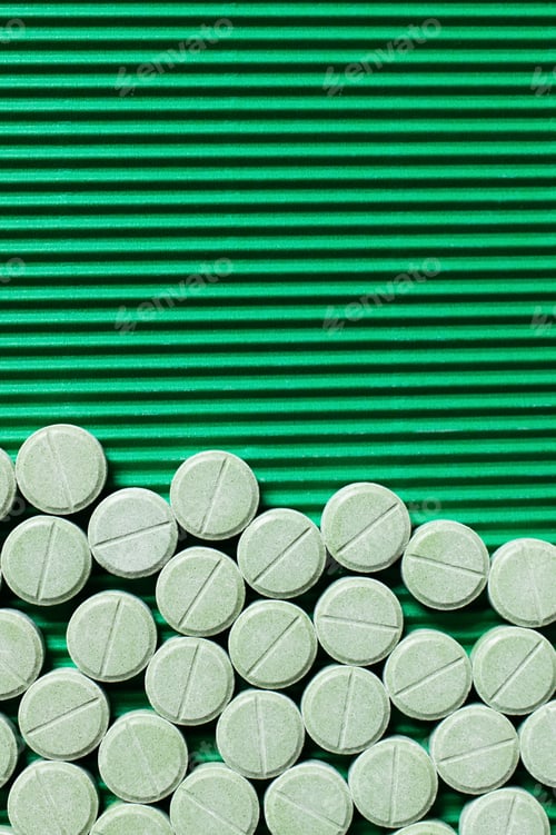Preview: Top View of Round Shape Medication on Textured Green Background