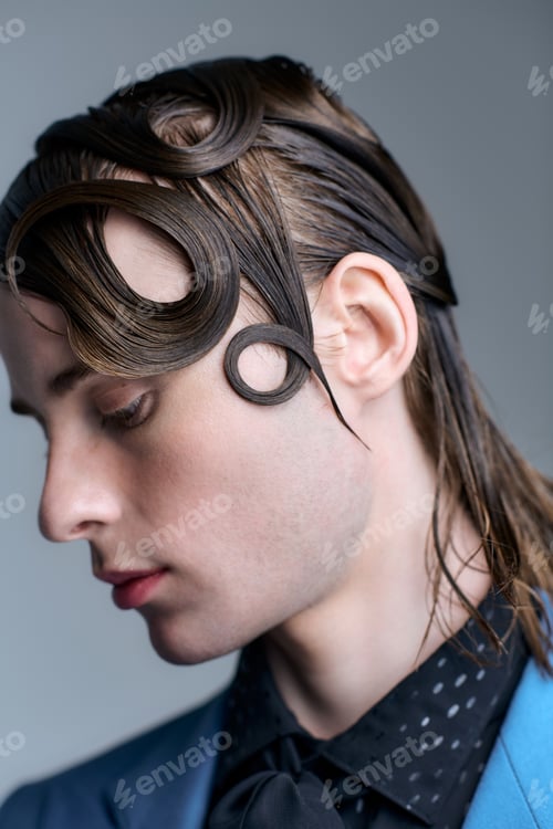 Preview: Stylish young man in a modern studio showcasing unique fashion trends and artistic hair