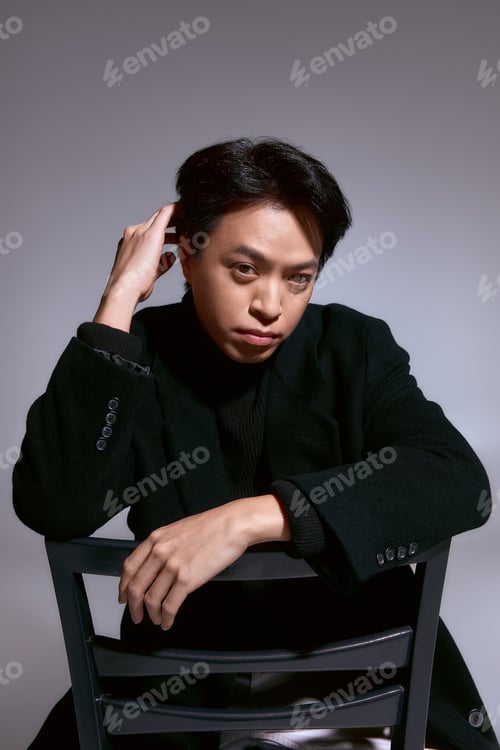 Preview: Stylish young man expressing modern fashion trends in a studio setting