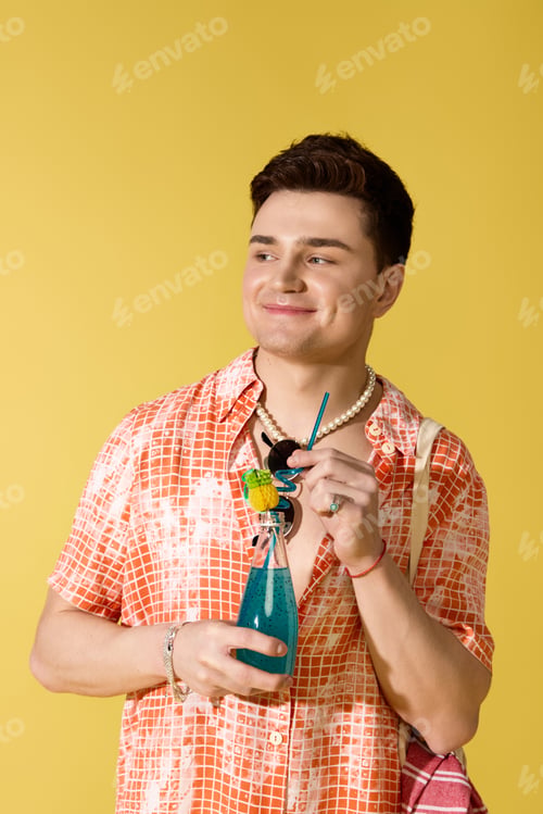 Preview: Stylish young man enjoying a refreshing drink against a vibrant summer backdrop