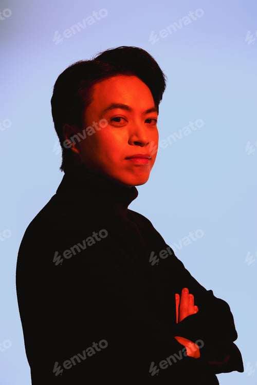 Preview: Stylish young man expressing his unique fashion sense in a creative studio setting