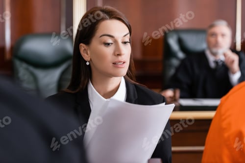 Preview: Brunette Prosecutor Reading Lawsuit in Court on Blurred Foreground