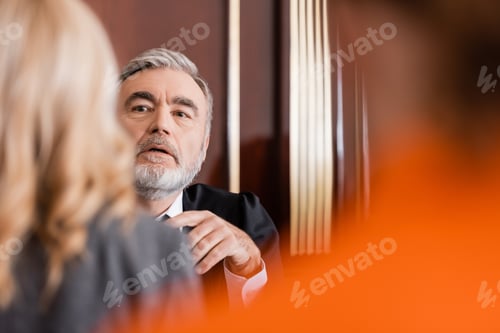 Preview: Senior Judge Talking to Blurred Attorney in Courtroom