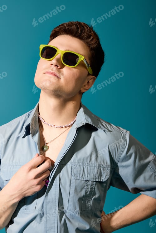 Preview: Stylish young man showcasing summer fashion with vibrant sunglasses and a confident pose