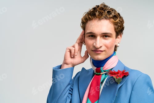 Preview: Stylish young man displays unique fashion sense in studio setting with vibrant colors