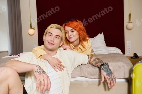 Preview: Young couple enjoys a relaxing vacation together in a modern hotel room