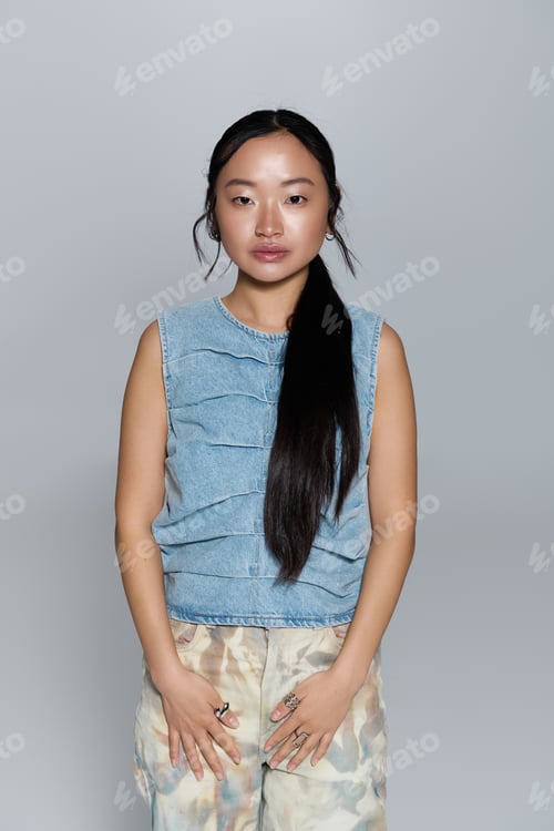 Preview: Elegant young woman showcases modern fashion with grace and poise in a serene setting