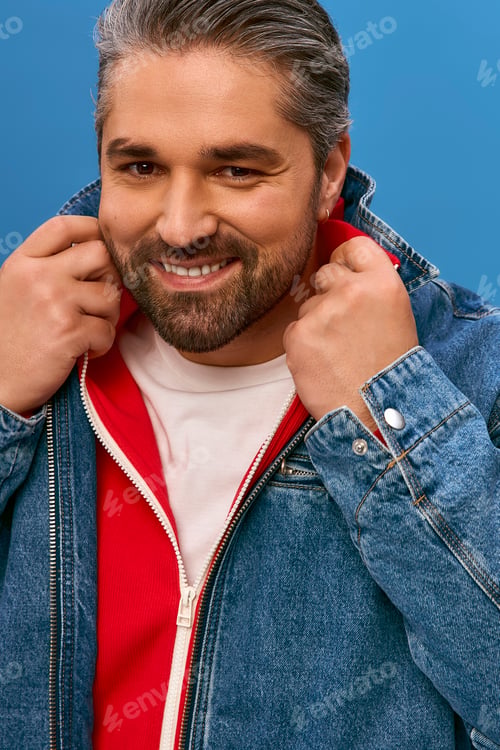Preview: Stylish man embracing modern fashion trends against a vibrant blue background