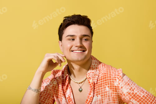 Preview: Stylish young man enjoying summertime with vibrant colors and a cheerful smile