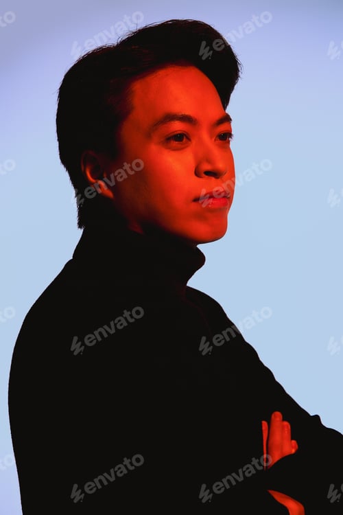 Preview: Stylish asian young man showcasing modern fashion sense in studio setting