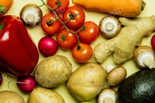 Preview: Top view of natural vegetables and avocado on yellow background