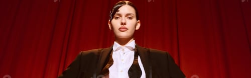 Vista previa: Beautiful artistic woman exudes confidence on stage in vibrant theatre setting