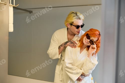 Preview: Blissful young couple enjoying a summer vacation at a modern hotel retreat