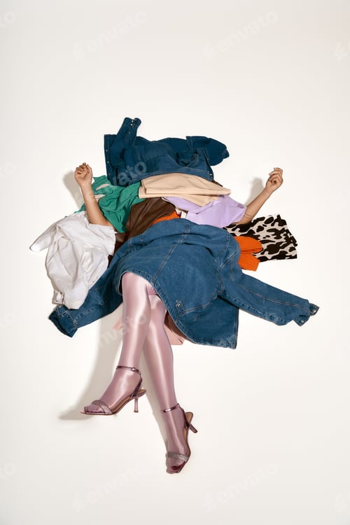 Preview: A stylish young woman poses playfully with colorful clothes on a bright backdrop