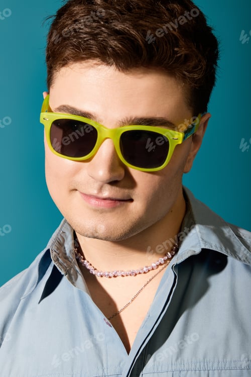 Preview: Stylish young man in bright sunglasses enjoys summer vibes with confidence and charm