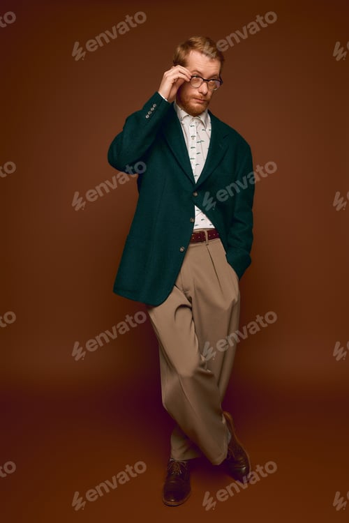 Preview: Handsome red haired man poses stylishly in a modern fashion setting with confidence