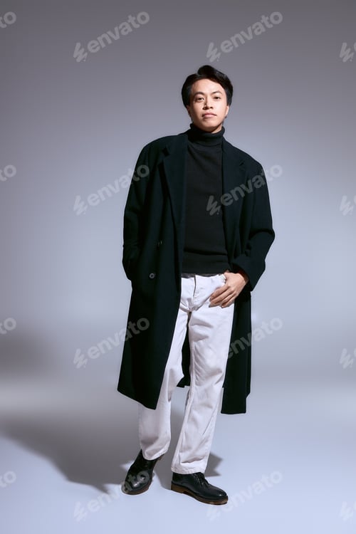 Preview: Stylish young Asian man expresses modern fashion in a creative studio setting