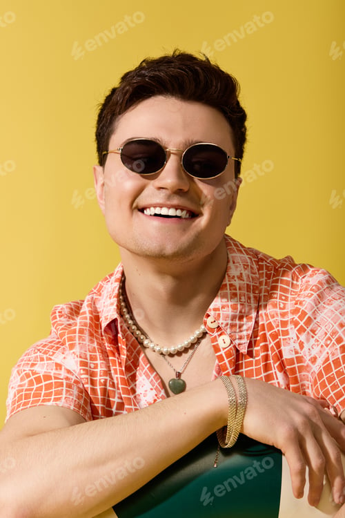 Preview: Stylish young man enjoying a vibrant summer day with cheerful fashion and bright colors