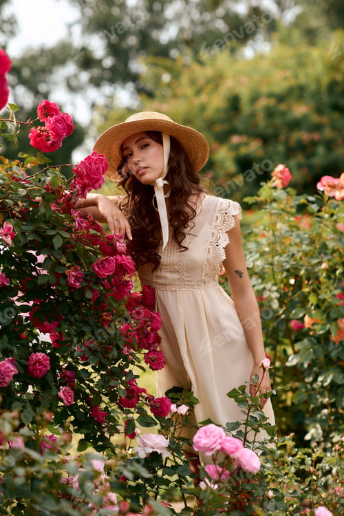 Preview: Beautiful young woman enjoying a serene moment in a vibrant flower garden