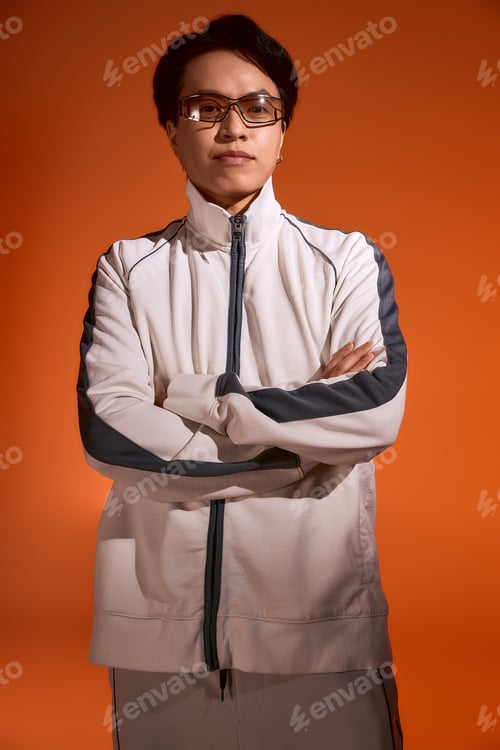 Preview: Stylish young asian man displaying fashionable attire in vibrant studio lighting