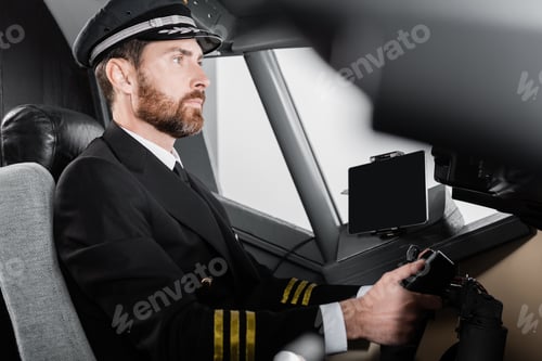 Preview: Side View of Bearded Pilot in Uniform Using Yoke in Airplane