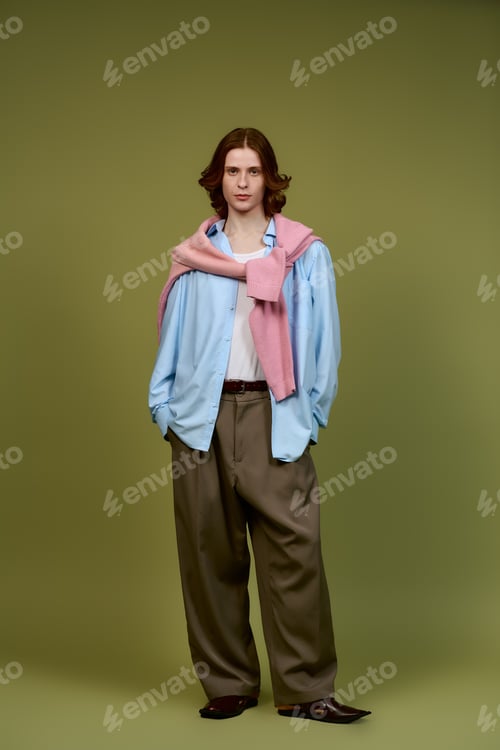 Preview: Young man showcases modern fashion trends in stylish studio portrait session
