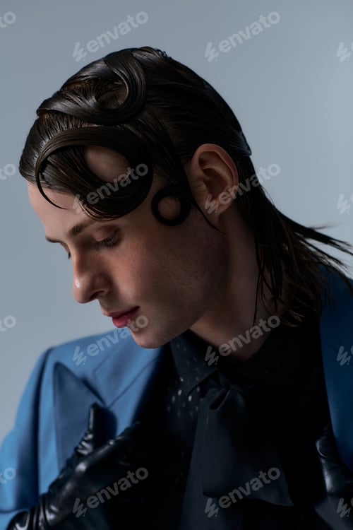Preview: Stylish young man showcasing modern fashion in a creative studio setting