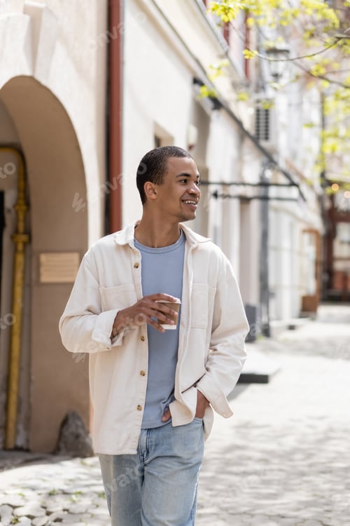 Preview: Happy African American Man in Shirt Jacket Holding Takeaway Drink and Walking With Hand in Pocket