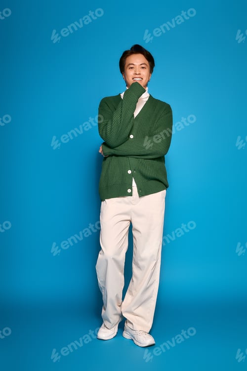 Preview: Stylish young man displays modern fashion in vibrant studio setting