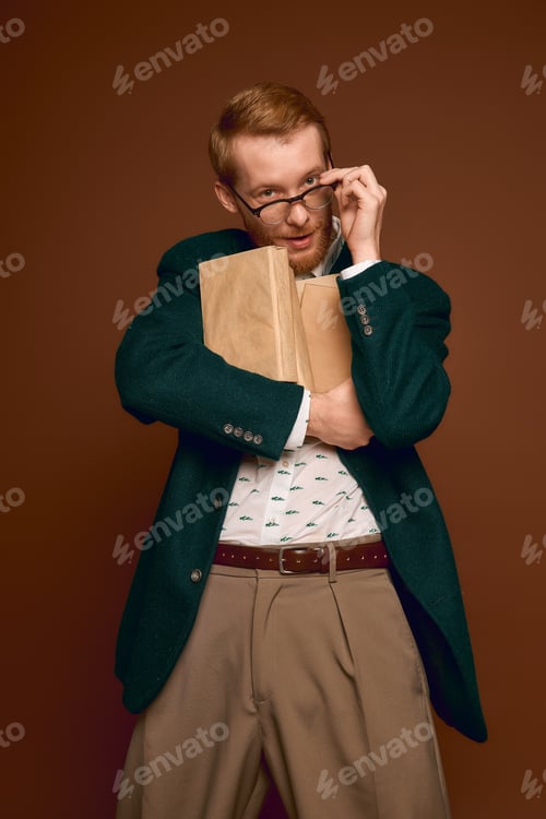 Preview: Handsome red haired man embraces style with confidence in a creative setting