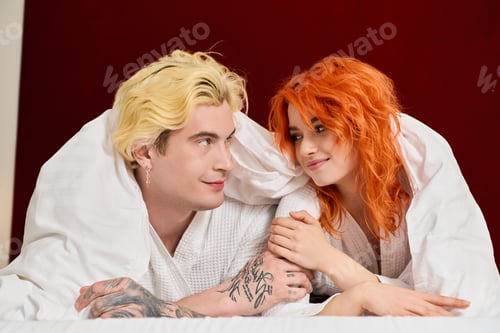 Preview: Beautiful young couple enjoys blissful vacation in modern hotel room together