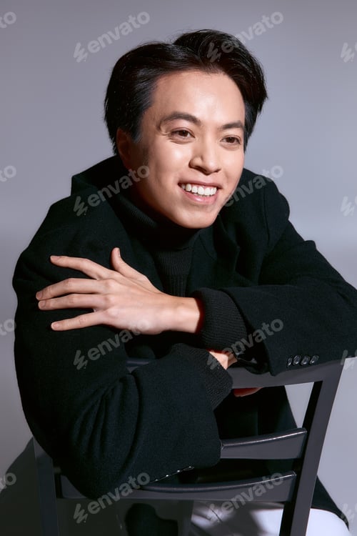 Preview: Stylish young man showcasing modern fashion in a creative studio setting