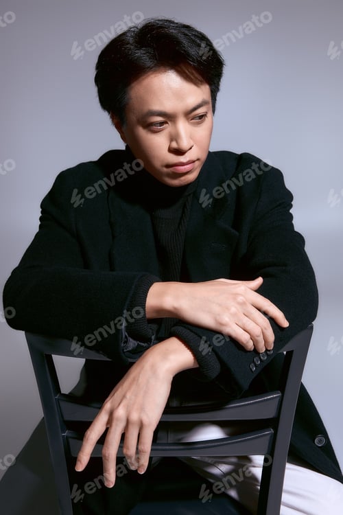 Preview: Young man displays modern style and confidence in a chic studio setting