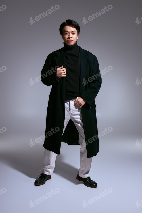 Preview: Stylish young man expressing fashion creativity in a modern studio setting